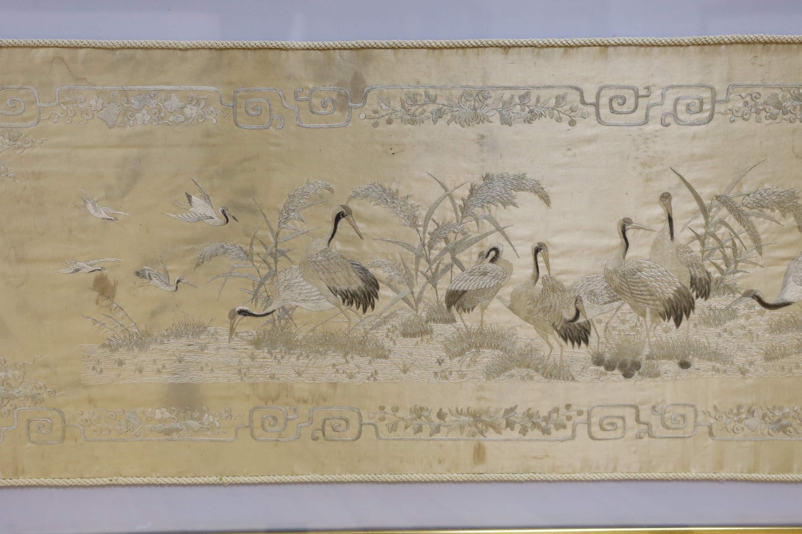 A Japanese silkwork panel, 39cm x 122cm